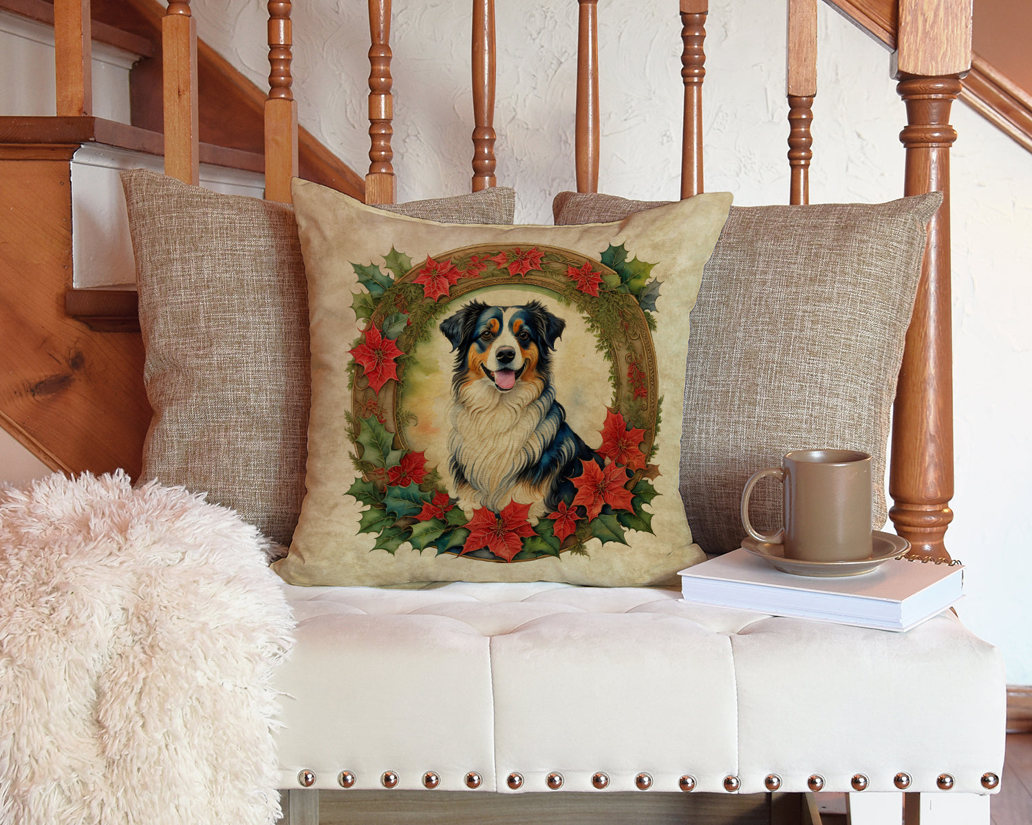 Pillows with dog and wreath design, mug and saucer on book, fuzzy blanket, white tufted bench, wooden stairs.