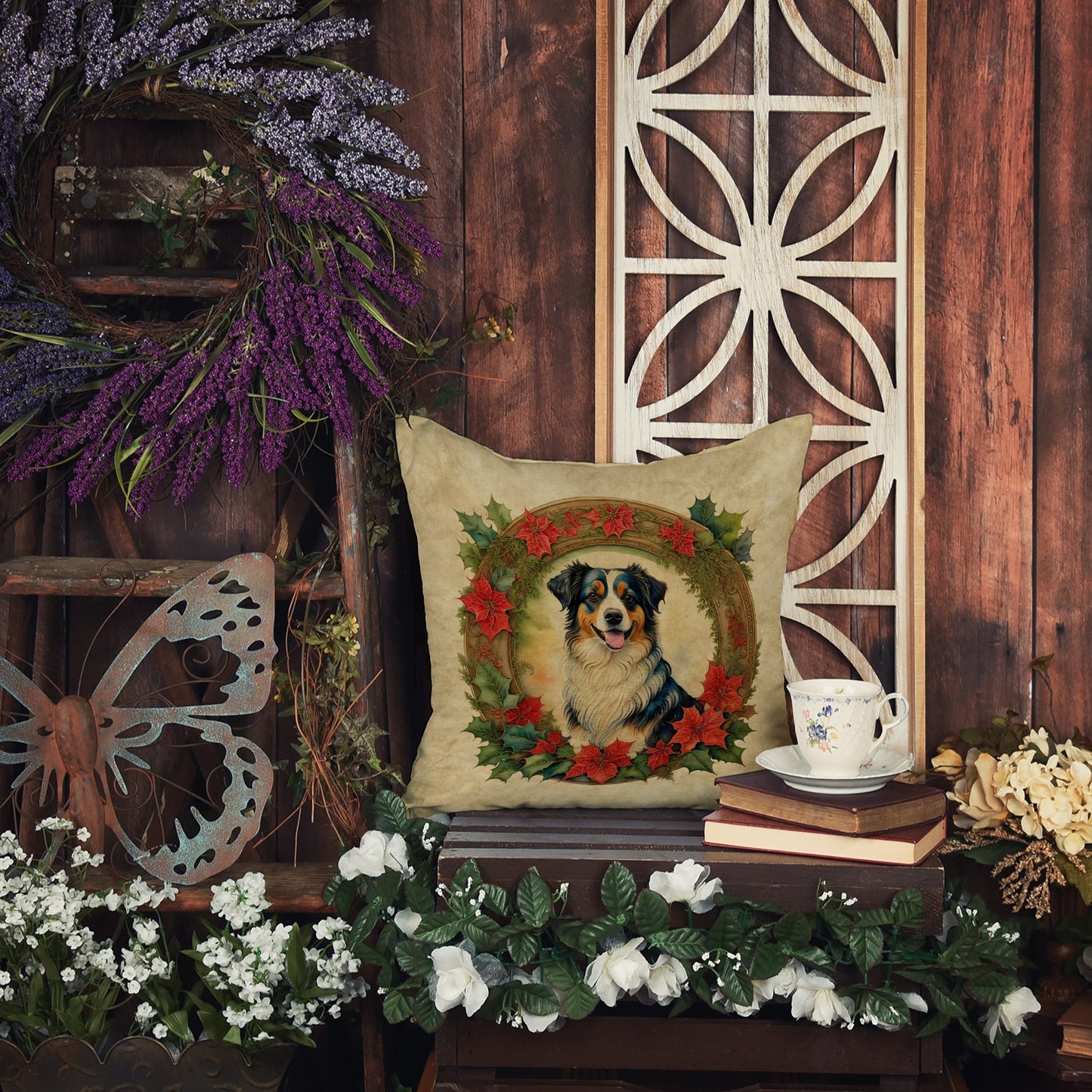 A rustic, decorative setup featuring a dog-themed pillow, surrounded by flowers, books, and wooden elements.
