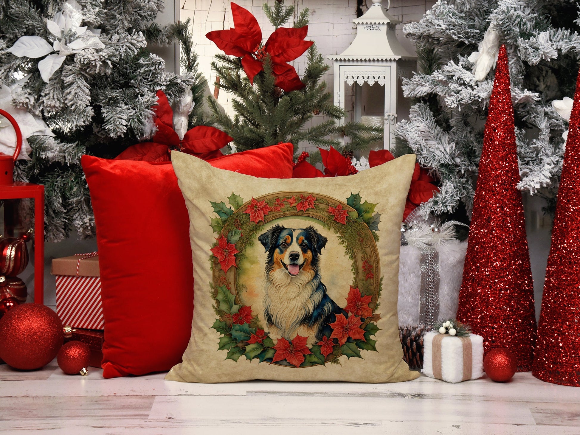 Christmas-themed scene with red glitter cone trees, white and flocked Christmas trees, red and white striped gift box, and a decorative pillow featuring a dog portrait surrounded by poinsettias.
