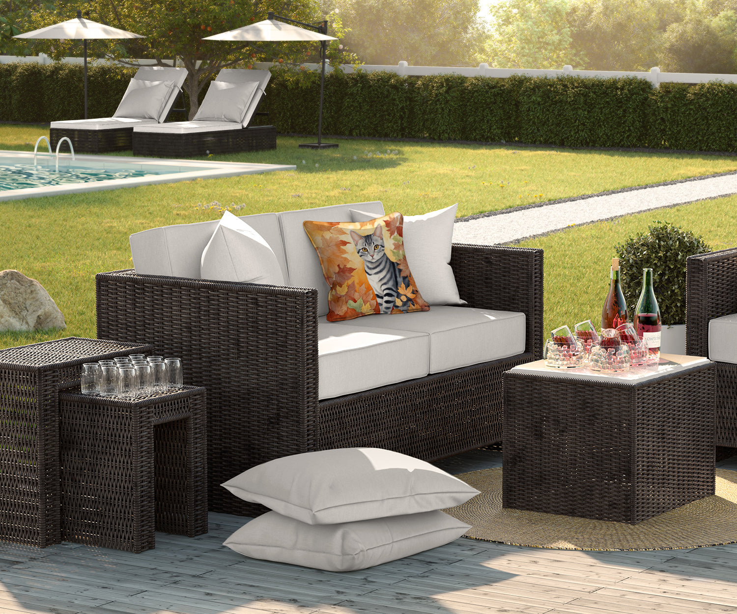 Outdoor patio furniture set with woven frames, light-colored cushions, and wine glasses on a table.
